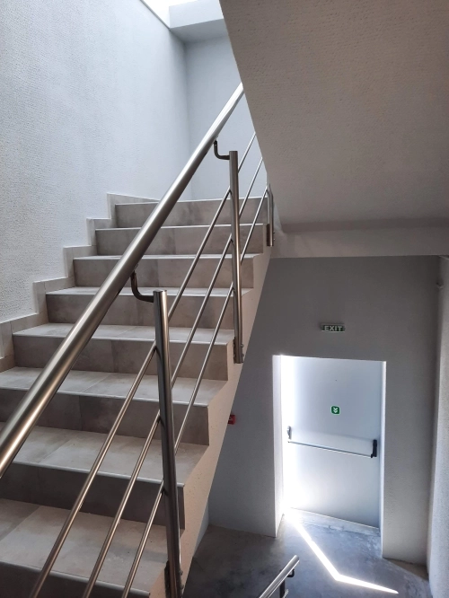 High quality interior staircase with stainless steel railing built by general contractor Bulgaria for residential construction partnership projects