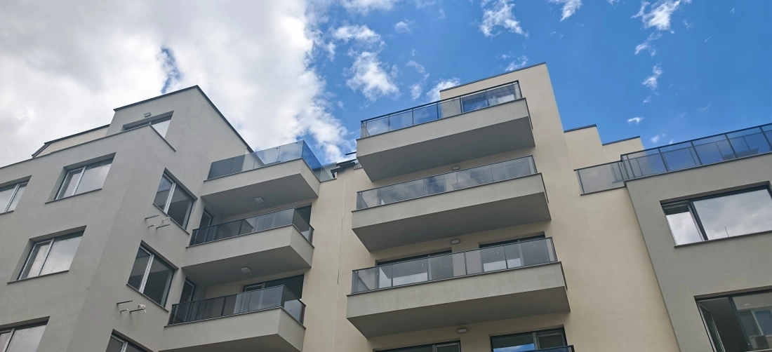 Modern residential building with glass balconies completed by reliable construction company Bulgaria seeking international partnership for new projects
